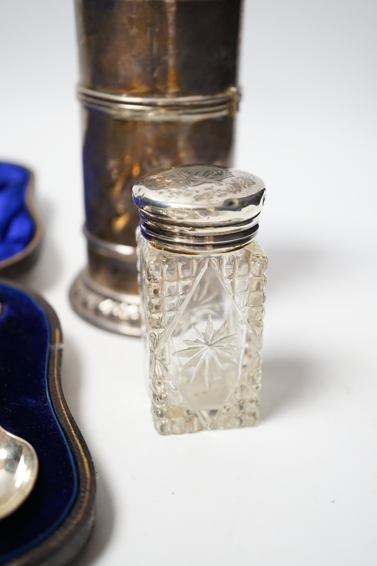 A cased set of twelve late Victorian silver teaspoons with tongs, William Hutton & Sons, London, 1898, a late Victorian silver lighthouse sugar caster, London, 1889, five assorted silver napkin rings and a silver mounted